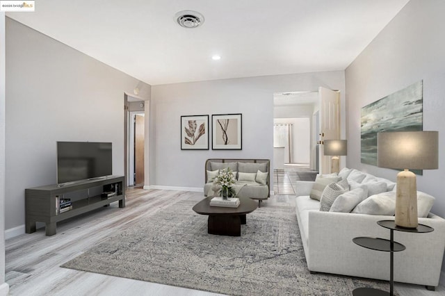 living room with light hardwood / wood-style flooring