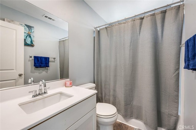 full bathroom with shower / tub combo with curtain, vanity, lofted ceiling, and toilet