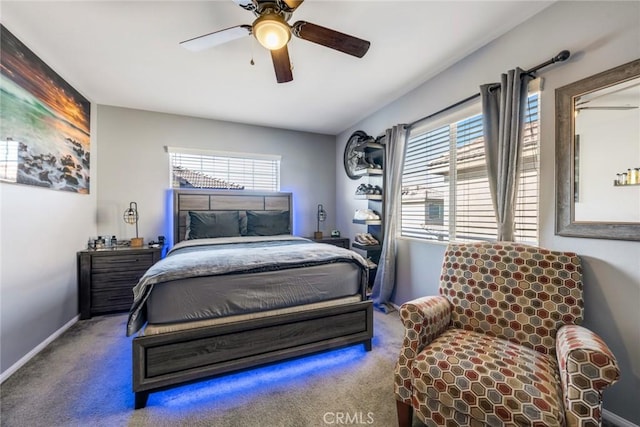 carpeted bedroom featuring multiple windows and ceiling fan