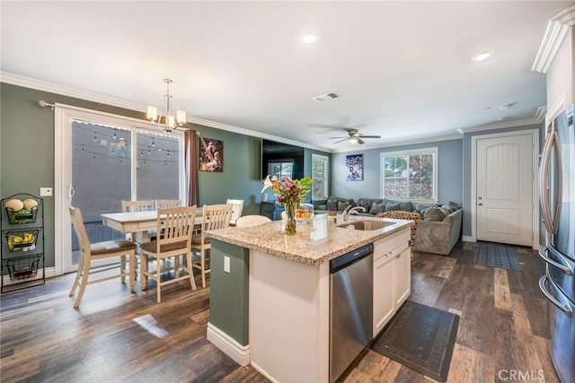 kitchen featuring sink, an island with sink, decorative light fixtures, white cabinetry, and stainless steel appliances