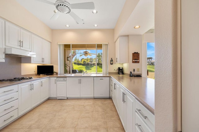 kitchen featuring kitchen peninsula, white cabinets, sink, dishwasher, and stainless steel gas stovetop