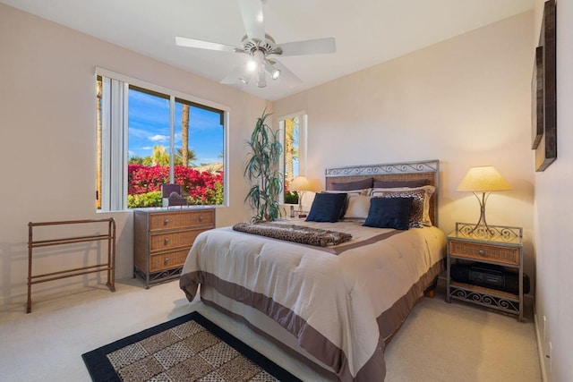 bedroom featuring light carpet and ceiling fan