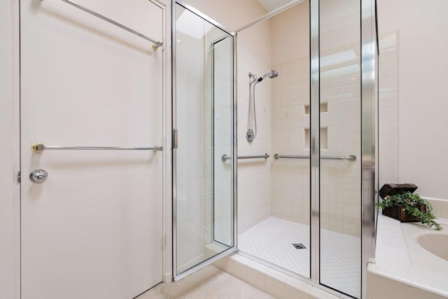 bathroom with a shower with door