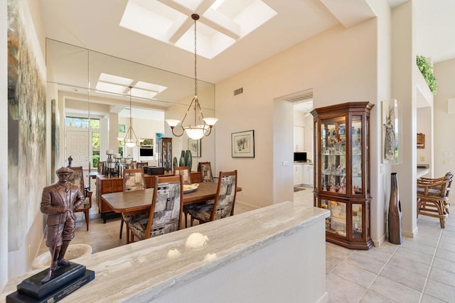 tiled dining area with a chandelier