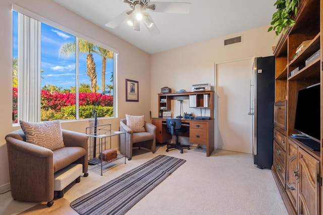 interior space with ceiling fan and light carpet