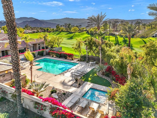 view of pool with a mountain view and a patio