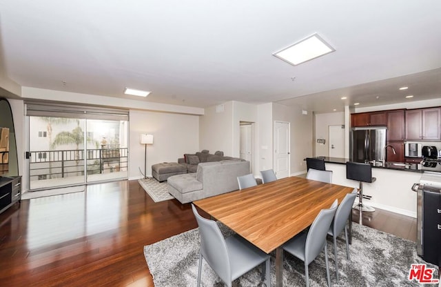 dining space featuring dark hardwood / wood-style floors and sink