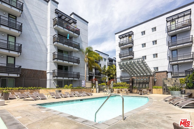 view of swimming pool with a patio