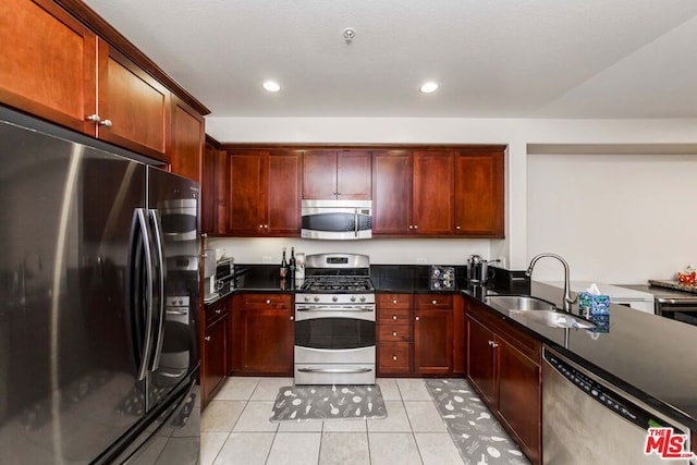 kitchen with light tile patterned floors, sink, and appliances with stainless steel finishes