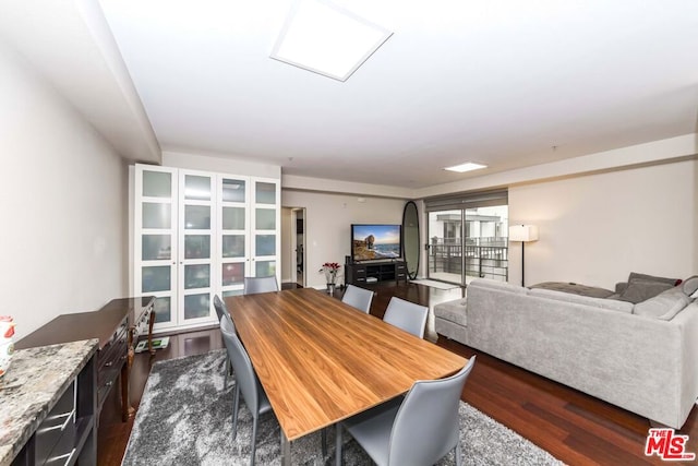 dining space with dark wood-type flooring