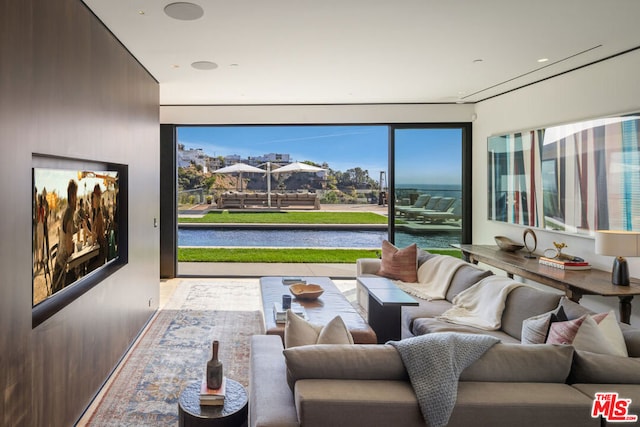 living room with a water view and golf simulator