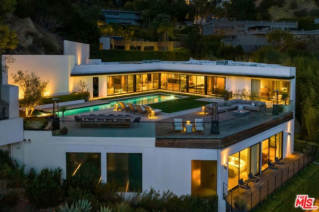 back of house featuring a patio area and a balcony