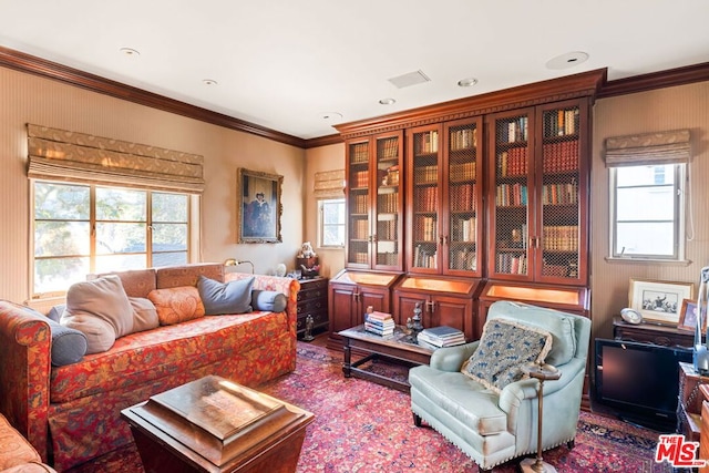 living room with crown molding and a healthy amount of sunlight