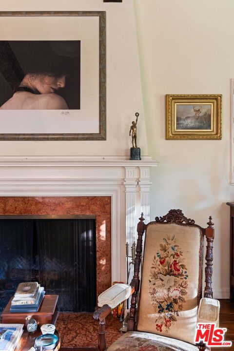 living area featuring a high end fireplace and wood-type flooring