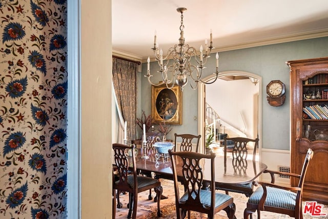 dining area with an inviting chandelier and ornamental molding