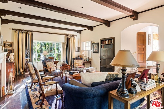 living room featuring beamed ceiling, dark hardwood / wood-style floors, and a premium fireplace