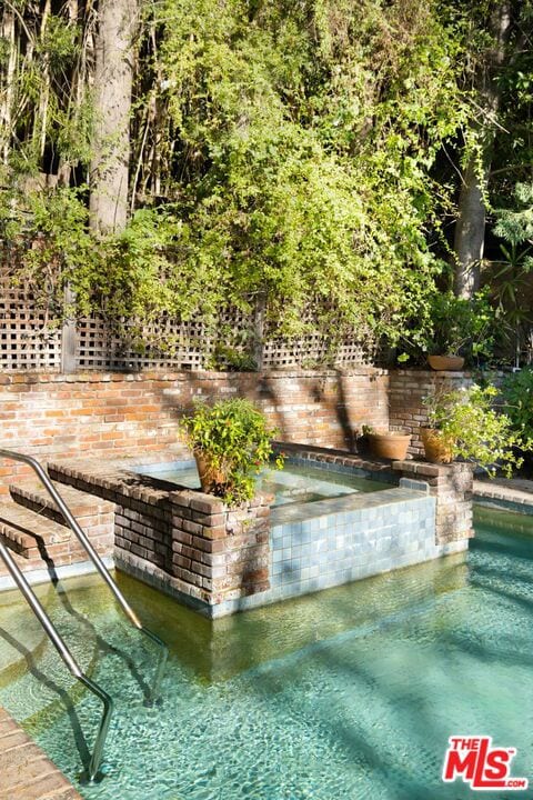 view of pool featuring a hot tub