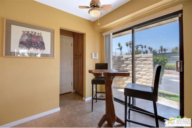 dining area featuring ceiling fan and light tile patterned floors