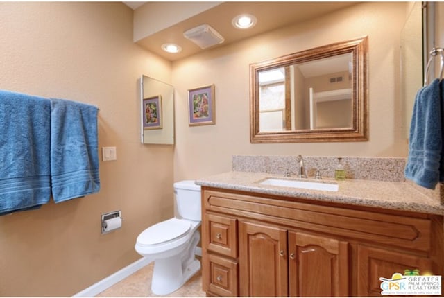 bathroom with tile patterned flooring, vanity, and toilet