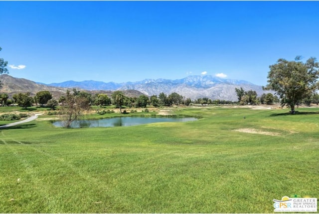 surrounding community featuring a lawn and a water and mountain view