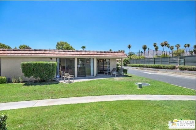 exterior space featuring a patio and a lawn