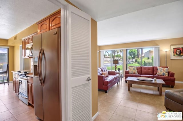 kitchen featuring light tile patterned floors and appliances with stainless steel finishes