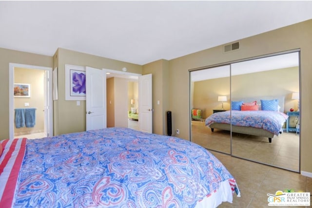 bedroom with a closet and light tile patterned floors