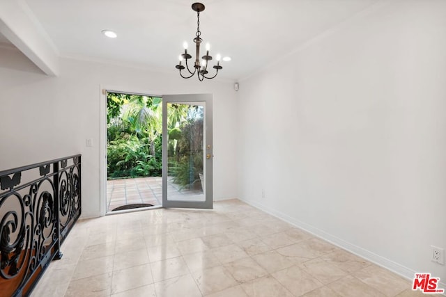 spare room featuring a chandelier and crown molding