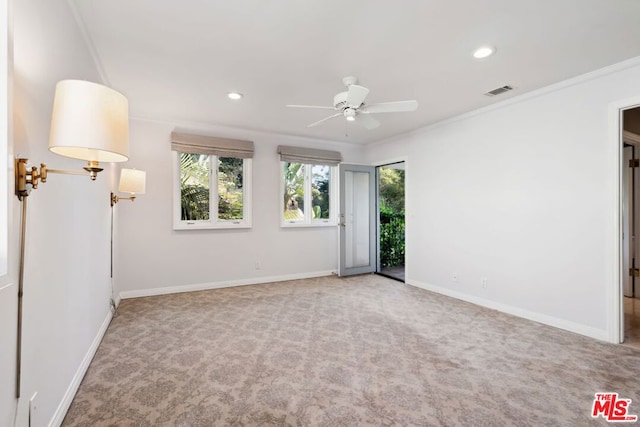 empty room featuring carpet flooring, ceiling fan, and ornamental molding