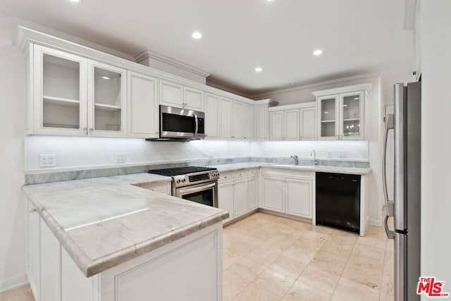 kitchen with white cabinetry, sink, light stone countertops, kitchen peninsula, and appliances with stainless steel finishes