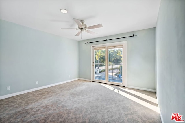 carpeted empty room featuring ceiling fan