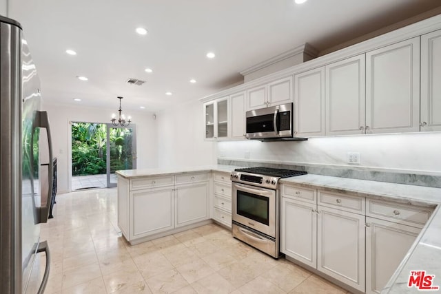 kitchen featuring kitchen peninsula, appliances with stainless steel finishes, decorative light fixtures, white cabinetry, and a chandelier