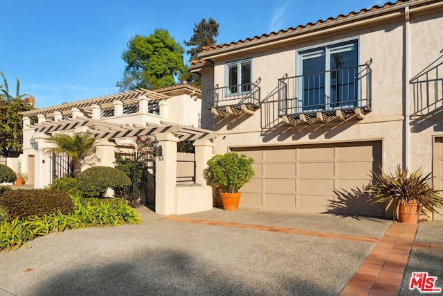 mediterranean / spanish-style house with a balcony and a garage