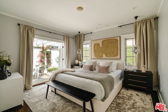 bedroom featuring access to exterior, dark hardwood / wood-style floors, and ornamental molding