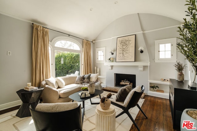 living room featuring hardwood / wood-style flooring, plenty of natural light, and vaulted ceiling