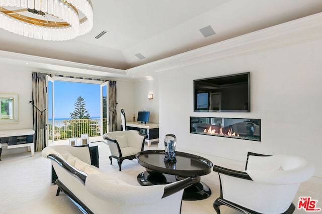 carpeted living room with a raised ceiling and crown molding