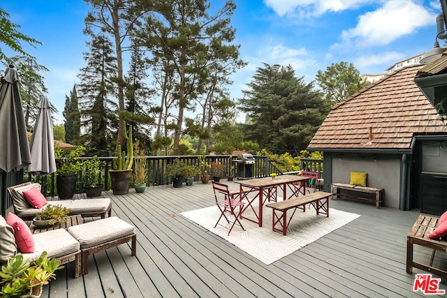 wooden deck featuring area for grilling