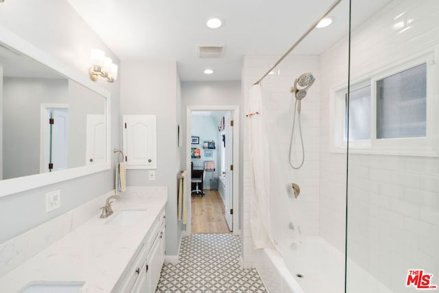 bathroom featuring vanity and shower / bath combination with curtain