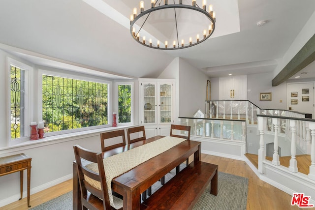 dining space featuring light hardwood / wood-style flooring and a notable chandelier