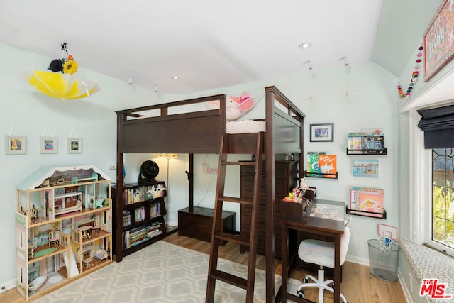 bedroom with hardwood / wood-style floors and vaulted ceiling