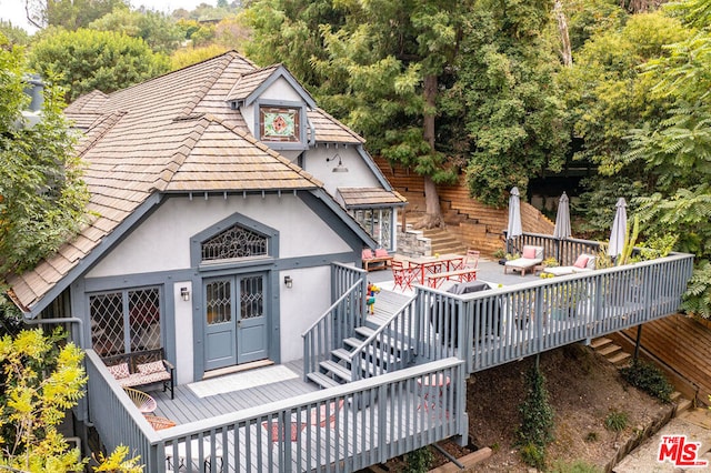 rear view of property with a wooden deck