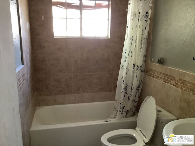 bathroom featuring shower / bath combination with curtain and toilet