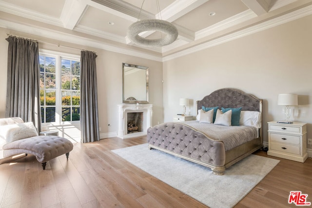 bedroom with ornamental molding and coffered ceiling