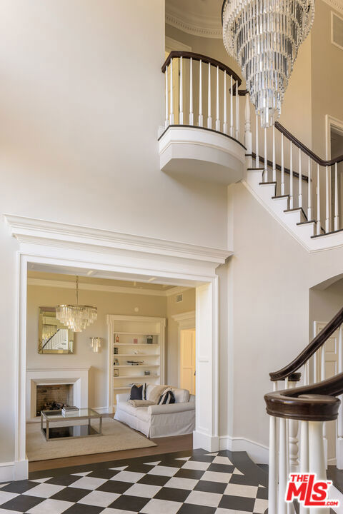 interior space with a towering ceiling and a notable chandelier