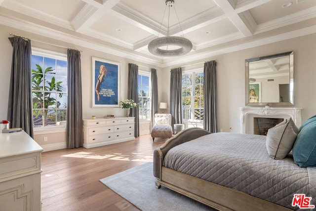 bedroom with light hardwood / wood-style floors, multiple windows, and crown molding