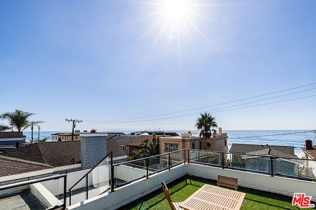 exterior space with a balcony and a water view