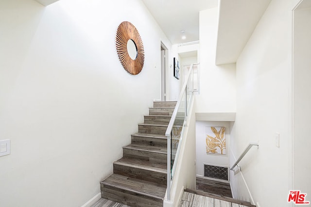 stairs with wood-type flooring