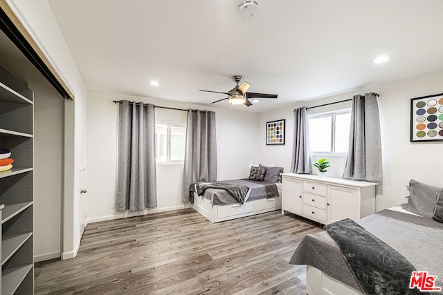 bedroom featuring multiple windows, ceiling fan, and light hardwood / wood-style floors