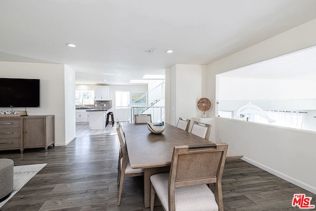 dining area with dark hardwood / wood-style floors