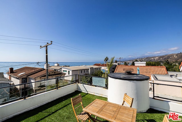 exterior space with a water view and a balcony